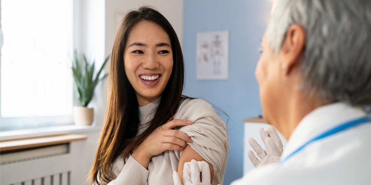 Doctor giving a patient a flu vaccine in a clinic